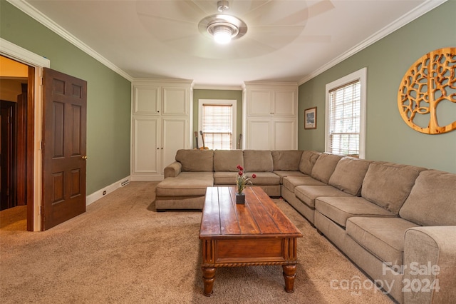 carpeted living room with ceiling fan and crown molding