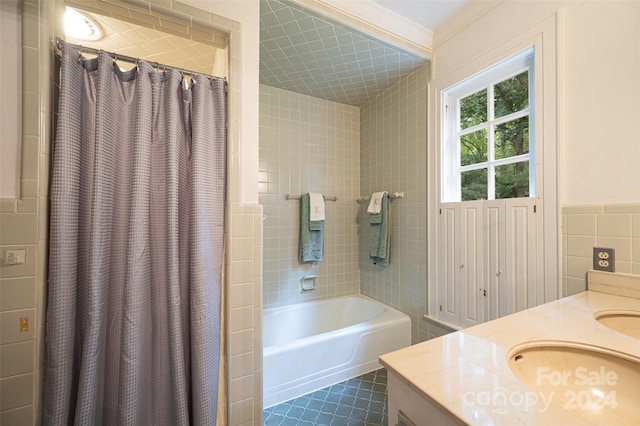 bathroom featuring tile patterned flooring, tile walls, shower / bath combo, and vanity