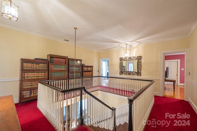 interior space featuring crown molding and a chandelier