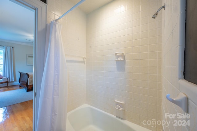 bathroom featuring shower / bath combo, ornamental molding, and hardwood / wood-style flooring