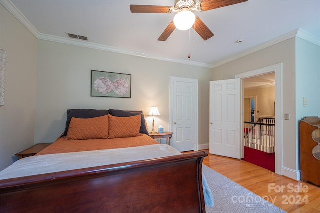 bedroom with ceiling fan, ornamental molding, and light hardwood / wood-style floors