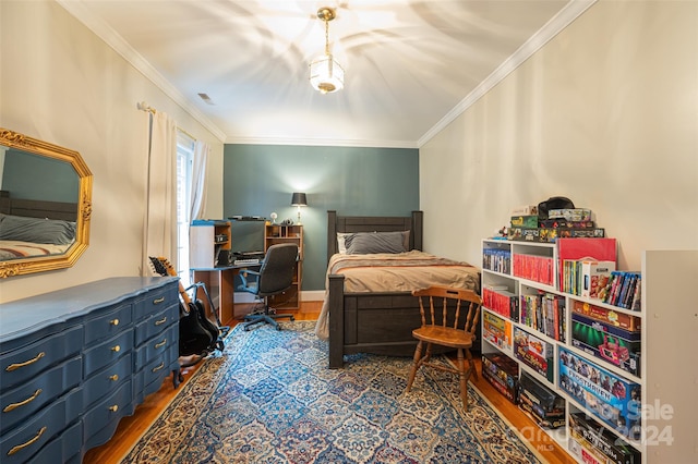 bedroom with wood-type flooring and crown molding