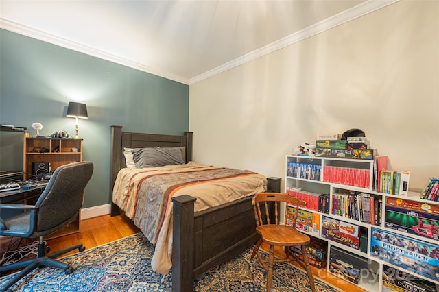 bedroom featuring ornamental molding and hardwood / wood-style floors