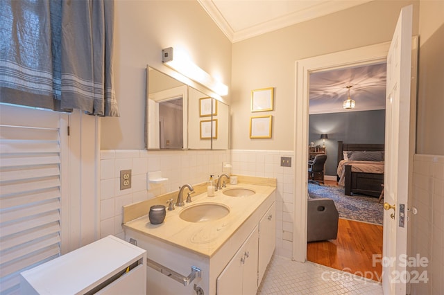 bathroom featuring tile patterned flooring, vanity, tile walls, and ornamental molding