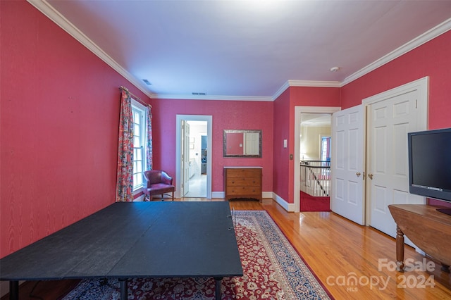 interior space with hardwood / wood-style floors and ornamental molding