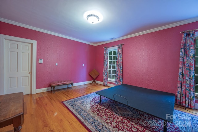 exercise room featuring crown molding and hardwood / wood-style flooring