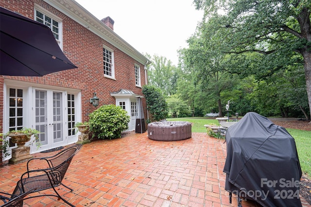 view of patio with area for grilling, an outdoor living space, and french doors