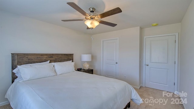 bedroom with ceiling fan and light colored carpet