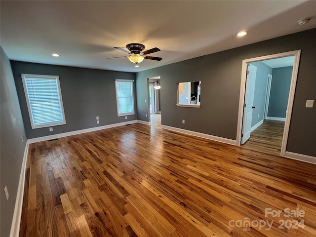 empty room featuring ceiling fan and hardwood / wood-style floors