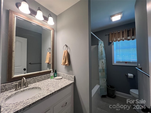 bathroom featuring toilet, vanity, a shower with shower curtain, and tile patterned flooring