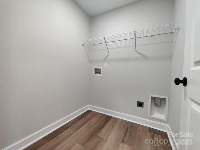 laundry area featuring washer hookup, hookup for an electric dryer, wood finished floors, laundry area, and baseboards