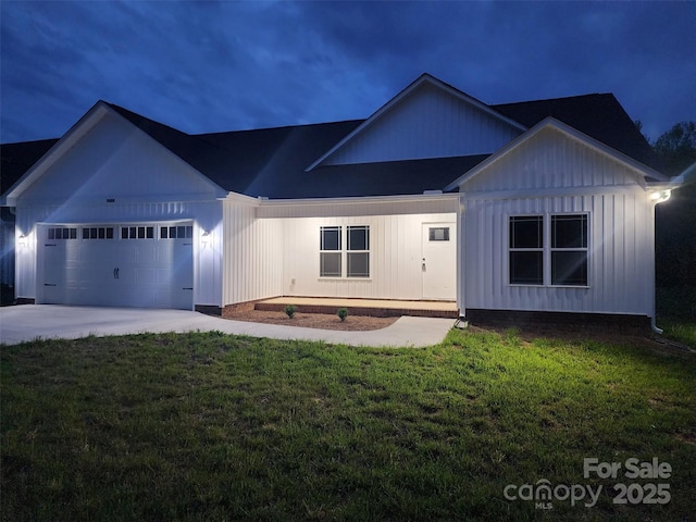 modern inspired farmhouse with board and batten siding, concrete driveway, a garage, and a front lawn