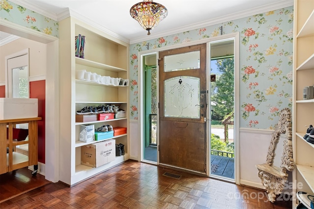 foyer featuring dark parquet flooring and ornamental molding