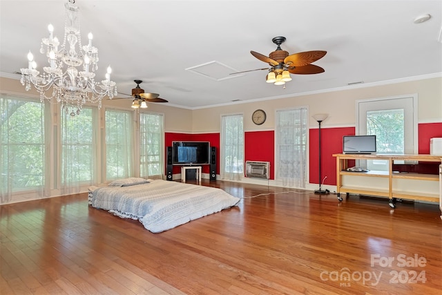 bedroom with hardwood / wood-style flooring, heating unit, and crown molding