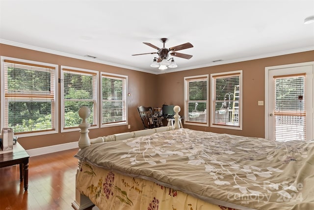 bedroom featuring crown molding, multiple windows, hardwood / wood-style flooring, and ceiling fan