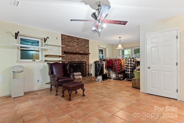 tiled living room featuring ceiling fan and a fireplace