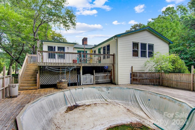 rear view of house featuring a deck