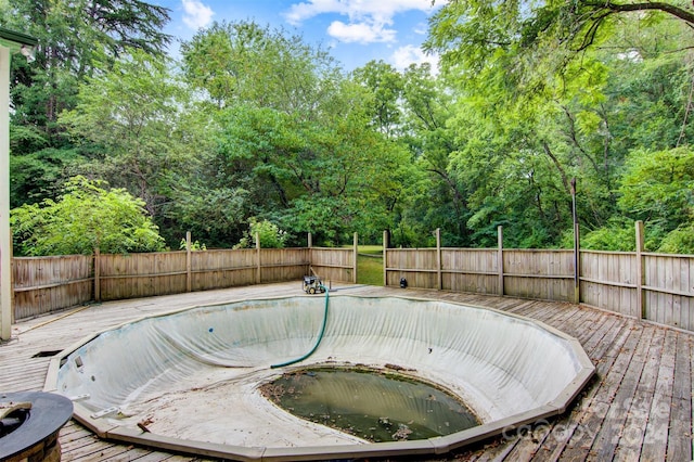 view of swimming pool with a wooden deck