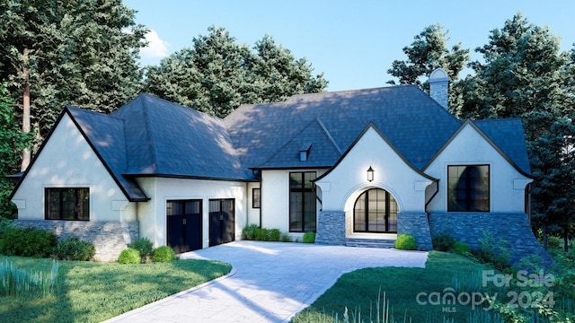 french country style house with a garage