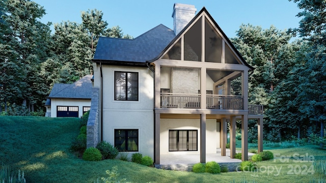 view of front of house with a balcony and a front lawn