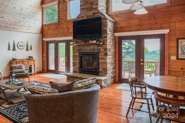 living room featuring a wealth of natural light, french doors, and high vaulted ceiling