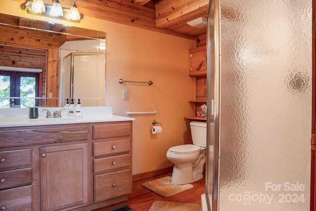 bathroom featuring hardwood / wood-style flooring, walk in shower, french doors, and vanity