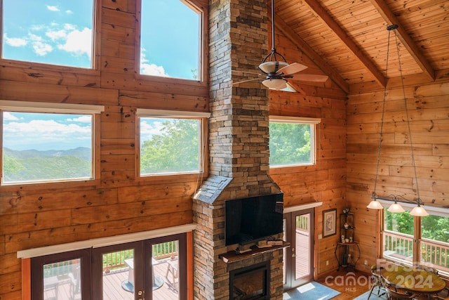 unfurnished living room with wooden ceiling, beam ceiling, a mountain view, and high vaulted ceiling