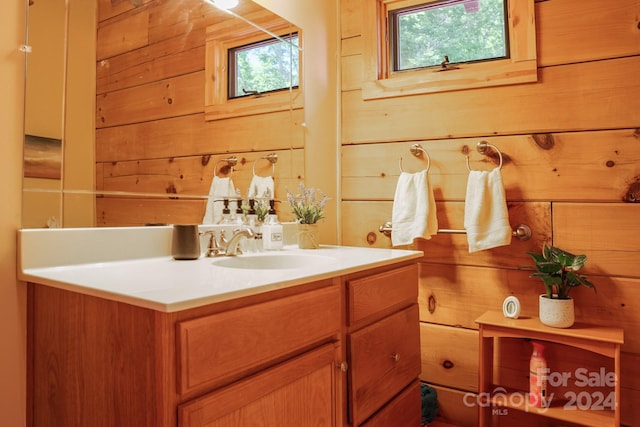 bathroom with vanity and wooden walls