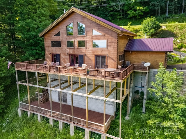 back of property with a deck and metal roof