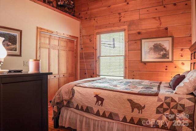 bedroom featuring wood walls and a closet