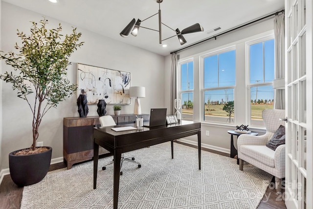 home office featuring an inviting chandelier