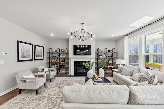 living room featuring hardwood / wood-style floors and a notable chandelier