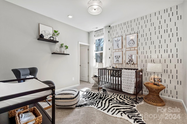 bedroom with carpet floors and a crib