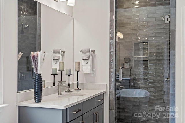 bathroom featuring walk in shower and vanity