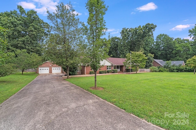 single story home featuring a garage and a front lawn