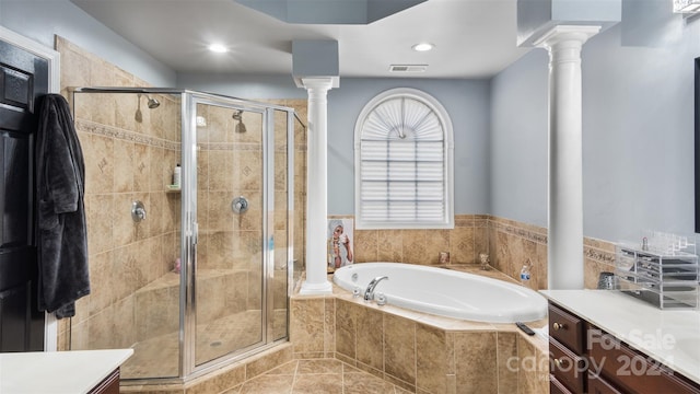 bathroom with vanity, separate shower and tub, and decorative columns