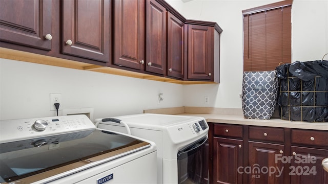 laundry room featuring cabinets and washer and dryer