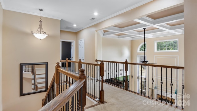 hall featuring beamed ceiling, light colored carpet, ornamental molding, and coffered ceiling