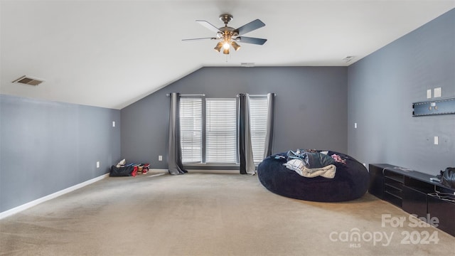 interior space with lofted ceiling, light carpet, and ceiling fan