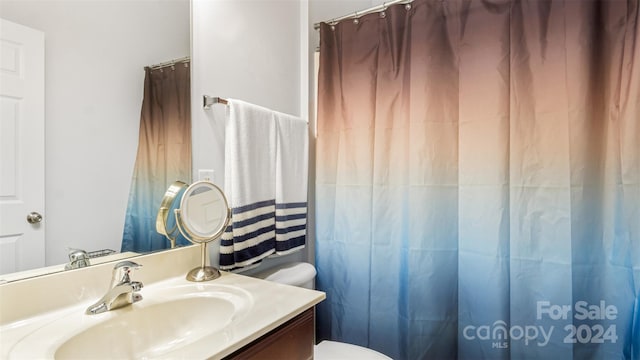 bathroom featuring vanity and toilet