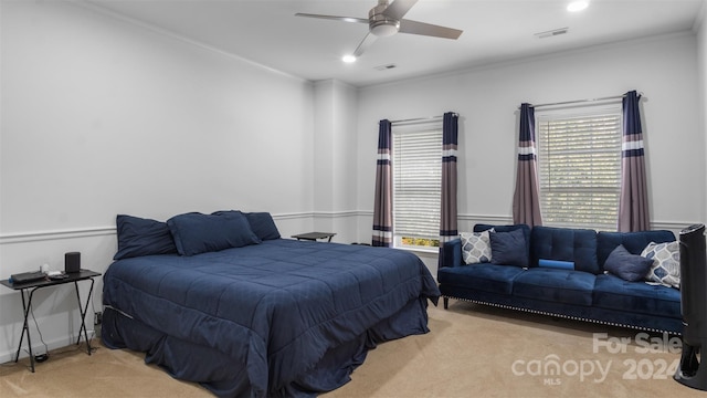 bedroom featuring light carpet, crown molding, and ceiling fan