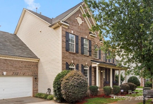 view of front of home with a porch and a garage