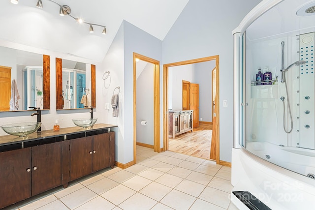 bathroom featuring lofted ceiling, vanity, tile patterned flooring, and combined bath / shower with glass door