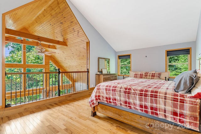 bedroom featuring wood ceiling, multiple windows, wood-type flooring, and lofted ceiling with beams