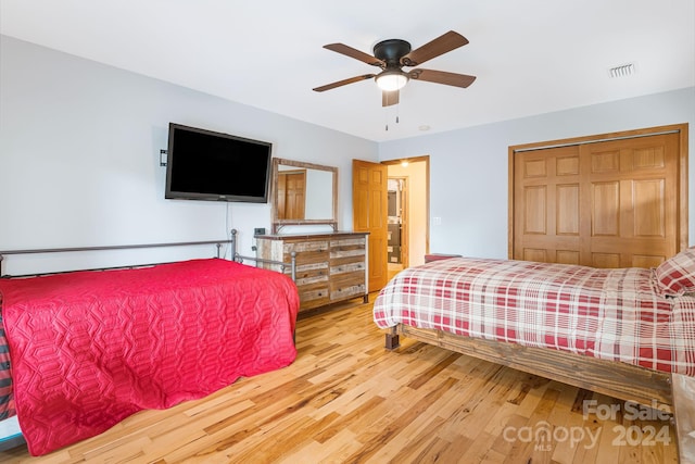 bedroom featuring ceiling fan, a closet, and hardwood / wood-style floors