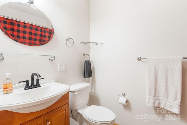 bathroom featuring toilet and vanity