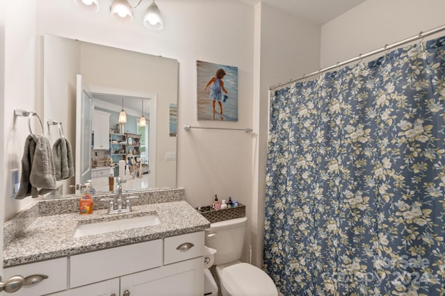 bathroom featuring vanity and toilet