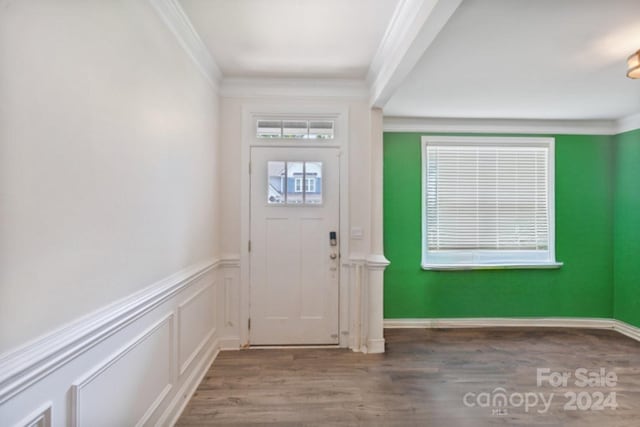 foyer with crown molding and wood-type flooring