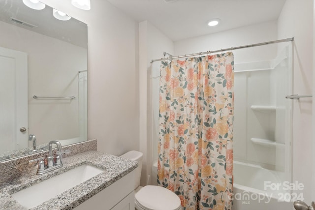 full bathroom with shower / bath combination with curtain, vanity, and toilet