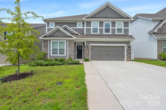 craftsman-style home with a garage and a front yard